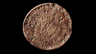 A round clay disc with symbolic inscriptions